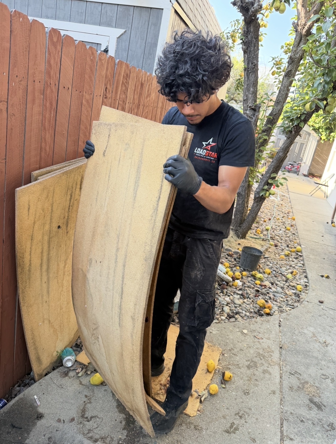 LoadStar team member hauling out old particle board